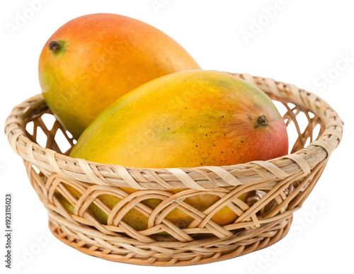 Fresh Organic Ripe Mangoes in Wicker Basket with Green Tropical Leaves