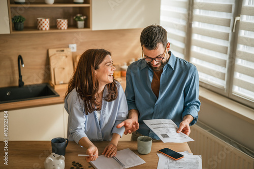 Bilde på lerret Couple discussing monthly budget and managing household finances