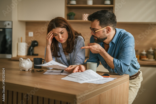 Photography Stressed young couple managing bills and financial problems at home