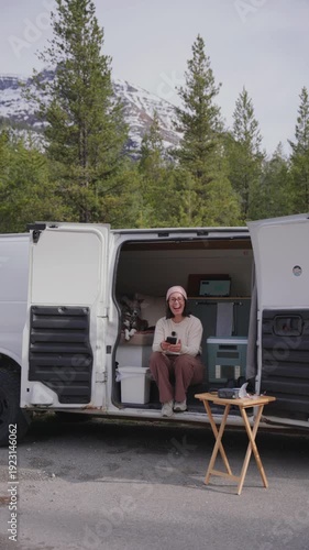 Wallpaper Mural Woman enjoying van life camping in nature with snow capped mountains and pine trees Torontodigital.ca