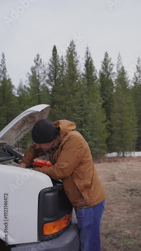 Wallpaper Mural Man fixing broken camper van motor outdoors Torontodigital.ca