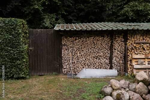 close up of a wood shed filled with firewood in Germany