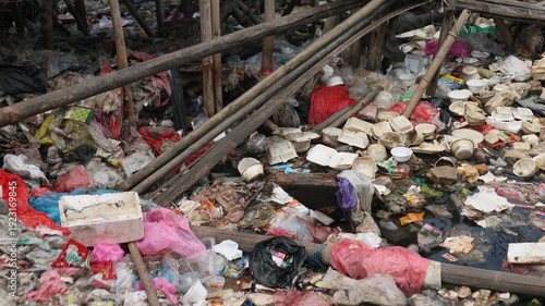 Plastic waste piled up in a river near a fishing port. The social issue of marine debris is difficult to resolve, especially in Asia.
