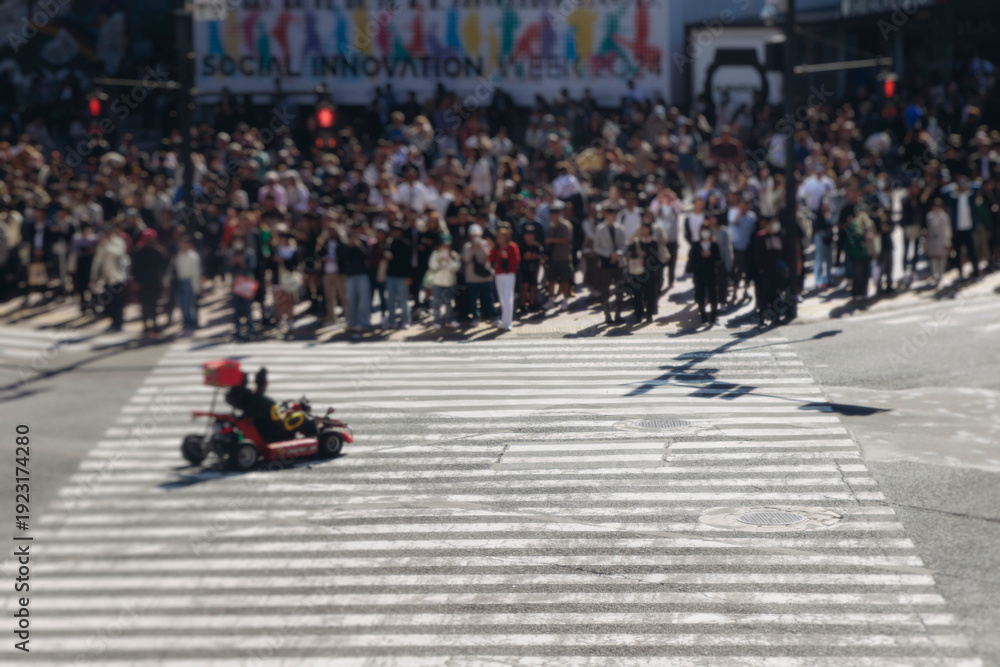Fototapeta premium Shibuya Scramble Crossing, Tokyo, crowd of pedestrians and tourists walking on pedestrian crossing intersection during rush hour, Shibuya Station, Tokyo, Japan, passer-by walk in a sunny day