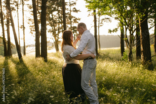 portrait of young happy couple dancing in nature in Auvergne, France