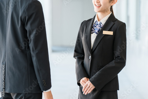 Young Asian businessmen in suits having a conversation in an office corridor