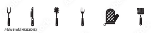 A collection of essential kitchen cooking and eating utensils including a roast fork, chefs knife, spoon, dinner fork, oven mitt, and basting brush, perfect for culinary and food