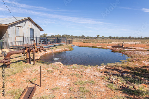 A borehole pipe delivers artesian bore water into a cooling pond  to power a hydro-electricity plant that is no longer used in the semi-arid region at Thargomindah in South West Queensland, Australia.