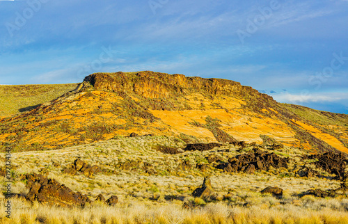 Ancient Lava Flow on Red Navajo Sandstone Hills at Snow Canyon State Park, Utah, USA
