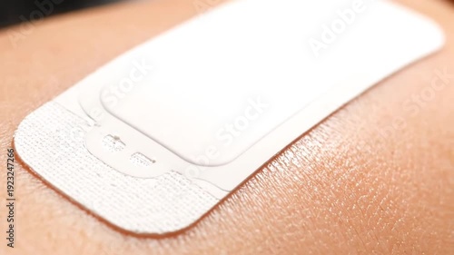 Adhesive Bandage Being Applied to Skin.