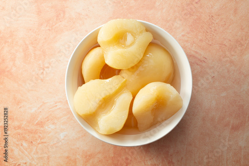 Cuadro en lienzo A top down view of a bowl of canned pears halves.