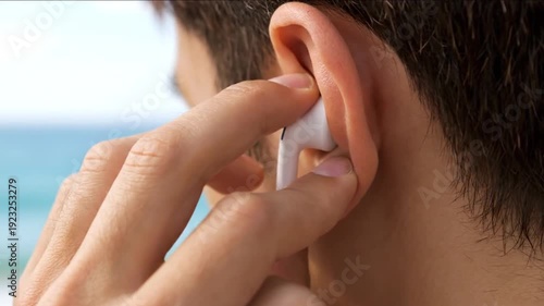 Man Using Wireless Earphones Near Ocean.