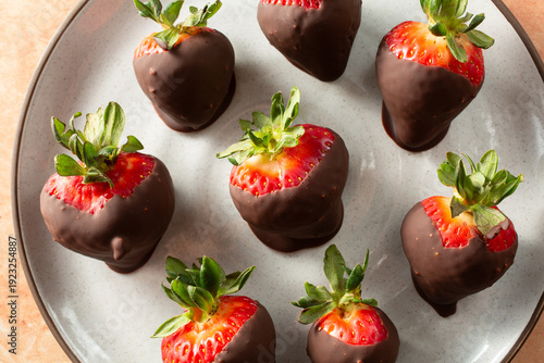 Принти на полотні A top down view of a pile of dark chocolate dipped strawberries.