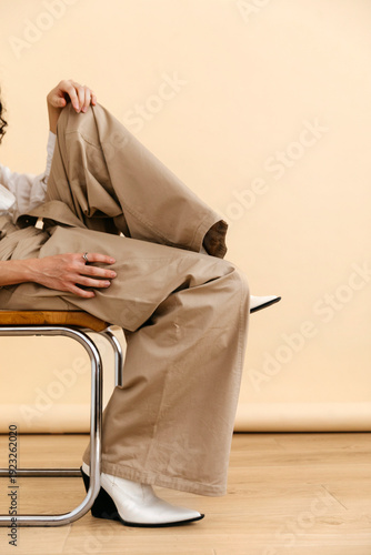 Anonymous  man posing in beige pants and white boots