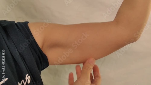 portrait the fingers holding the flabbiness adipose sagging skin, Flabby skin and loose under the arm of the woman, health care and beauty concept.