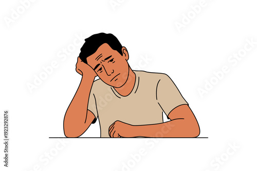 A frustrated man sitting at a table with his head in his hand, looking stressed and overwhelmed.