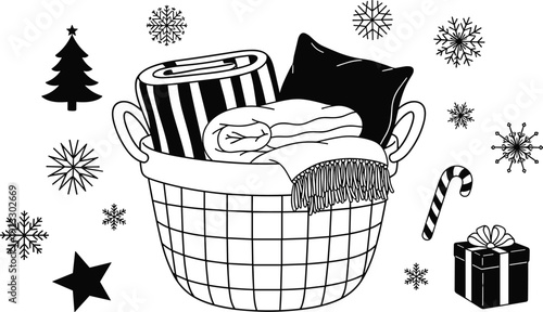Wicker laundry basket filled with cozy blankets and pillows surrounded by snowflakes christmas tree gift and candy cane for winter