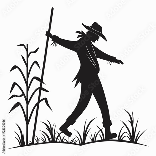 A black silhouette of a scarecrow standing in a field