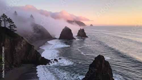 Dramatic coastline with sea stacks and rolling fog over rocky cliffs at sunset capturing cinematic ocean waves and moody nature