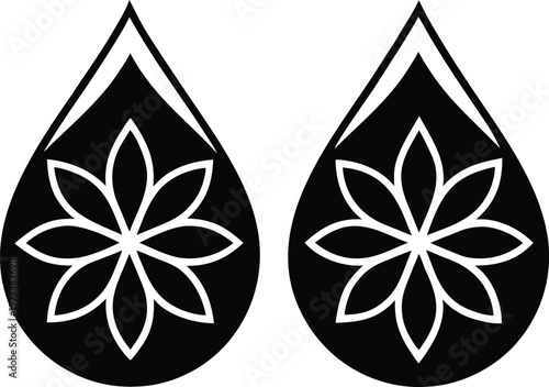 Two black teardrop shapes each containing a white floral like design