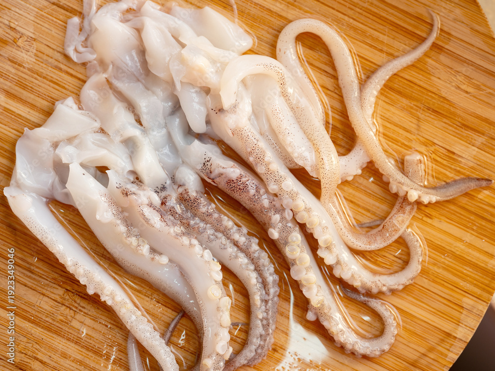 custom made wallpaper toronto digitalRaw squid legs on a wooden cutting board