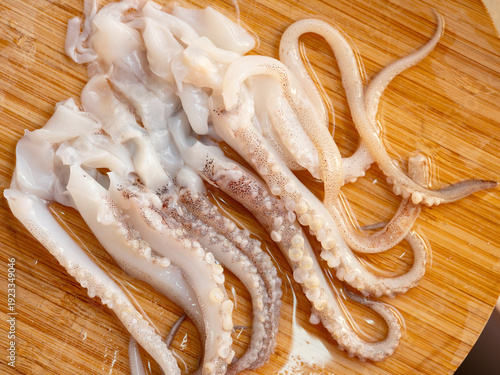Wallpaper Mural Raw squid legs on a wooden cutting board Torontodigital.ca