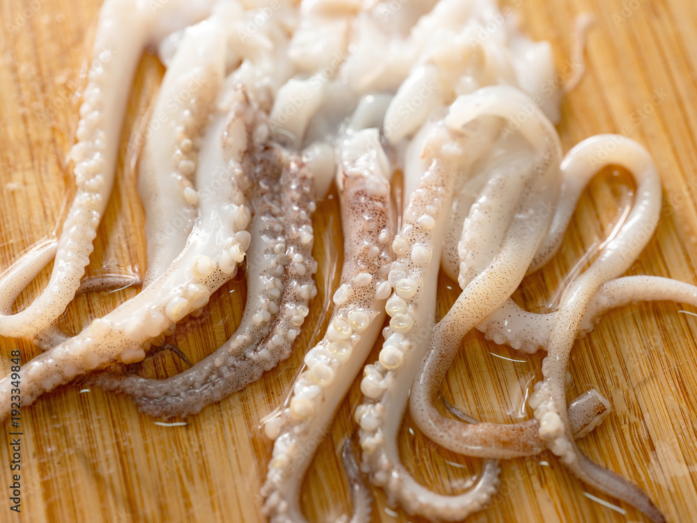 custom made wallpaper toronto digitalRaw squid legs on a wooden cutting board