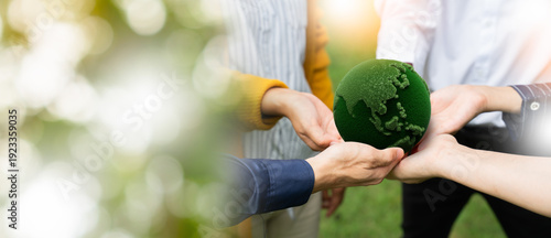 Fotografía panoramic of hands people holding a green moss globe together in a park