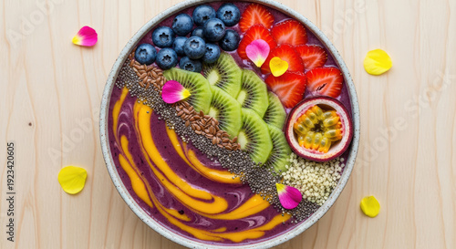 A vibrant and healthy bowl of fruit and seeds on a wooden table