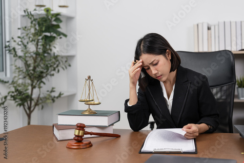 Fotografie Stressed Female Lawyer Reviewing Case Files