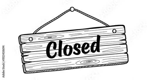 A closed sign hangs on a wooden board indoors.