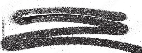 Closeup of a black hair clip covered in fine black sand particles.