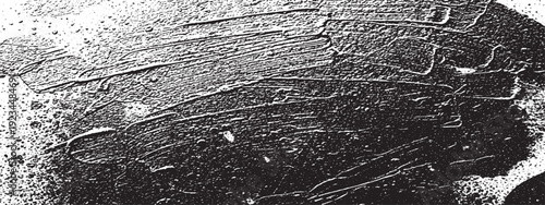Closeup of a tire tread pattern on a rough surface.