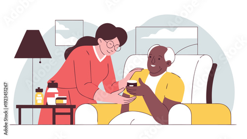 Compassionate home caregiver hands a jar of cream to a smiling senior man sitting in a yellow armchair.