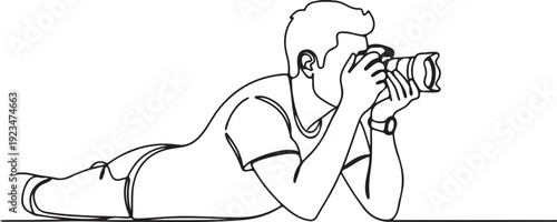 Man lying down holding camera to face photographer one line black and white