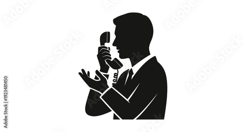 Man in suit speaking into microphone.