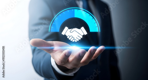 Businessman presenting a handshake icon with a blue graph on his palm in a professional setting with a grey background