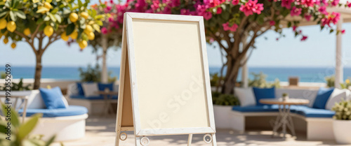 White empty chalkboard or easel stand on a sunny terrace by the sea with copy space for cafe menu. Relaxing summer vacation concept.