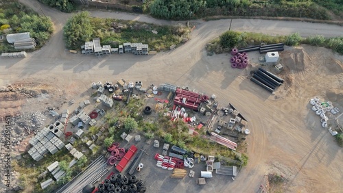 Fotografie Industrial construction site seen from aerial top view showing varied building materials including pipes
