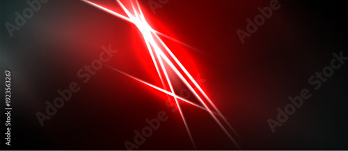 Abstract red light beams radiate from bright central point against dark background. Dramatic energy, dynamic composition.