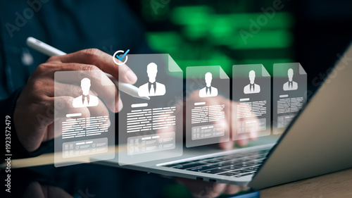 Business person reviewing digital resume profiles on laptop. Concept of recruitment, human resources, hiring, and online candidate selection.