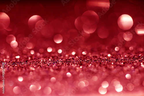 Pink, red white glittering Christmas lights. Blurred abstract bokeh background.