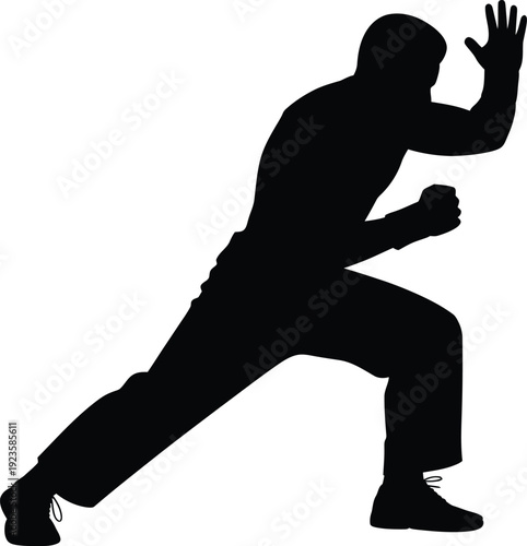 Silhouette of martial arts fighter in defensive stance with raised hand and clenched fist, ready for combat or training exercise