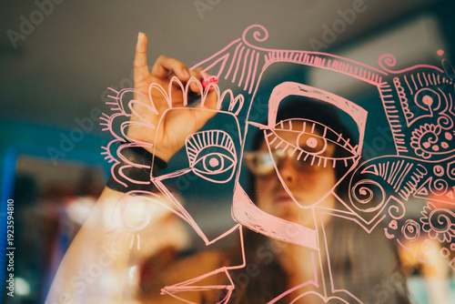 Wallpaper Mural Female artist drawing dribbles on art studio window Torontodigital.ca