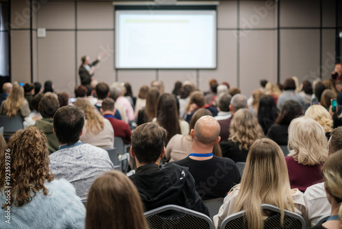 Wallpaper Mural Crowd listening to business presentation, focused audience in modern conference room, professional meeting atmosphere, networking energy. Torontodigital.ca