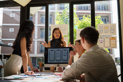 UX UI designers brainstorming and presenting mobile application layouts with wireframes and mockups.