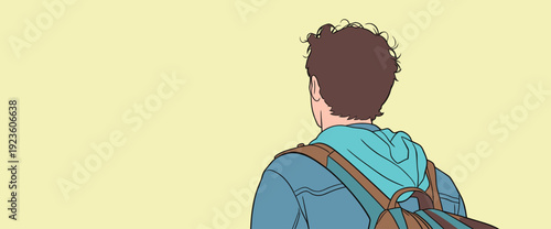 A person with curly hair stands with their back to a plain background. They wear a jacket and carry a backpack.