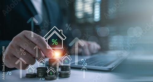 Photography Businessman hand putting coin on stack with virtual house and percentage icon