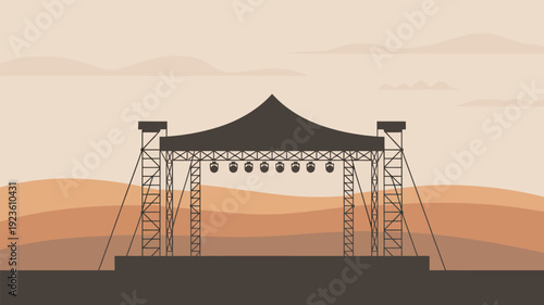 A large outdoor stage with a canopy and lighting set up in a desert landscape