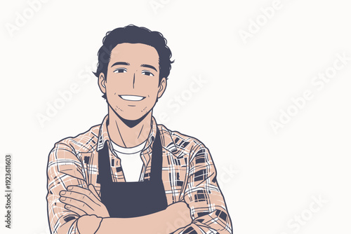 A young man smiles while standing with arms crossed, wearing an apron in a light, simple setting during daylight hours.